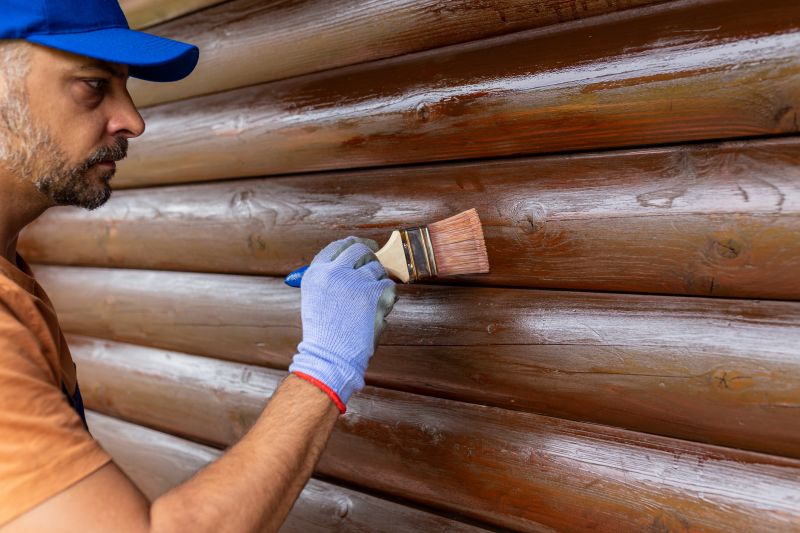 Wood siding being stained